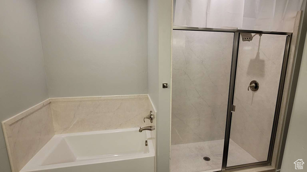 Full bath featuring a stall shower and a bath