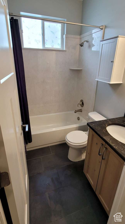 Full bath with toilet, tile patterned floors, shower / bath combination with curtain, and vanity
