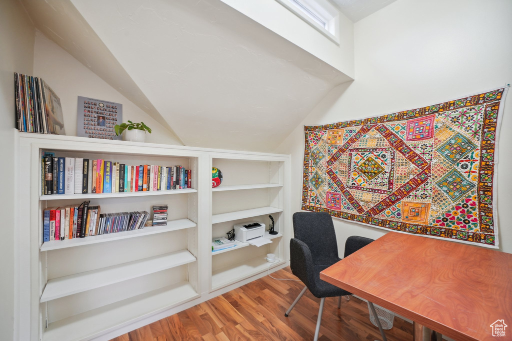 Home office with wood finished floors and lofted ceiling