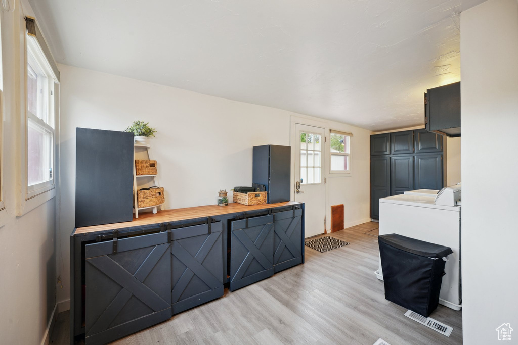 Interior space with baseboards, visible vents, and light wood finished floors