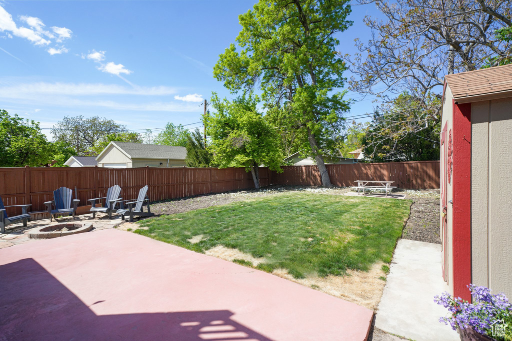 View of yard with an outdoor fire pit, a patio, and a fenced backyard