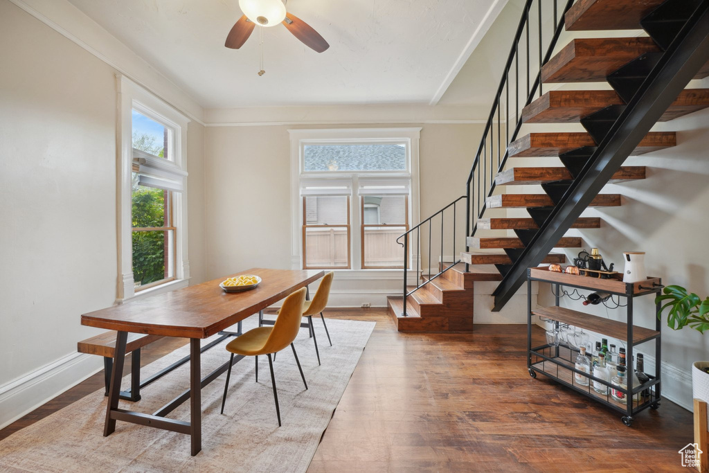 Dining area with stairway, ceiling fan, wood finished floors, and baseboards