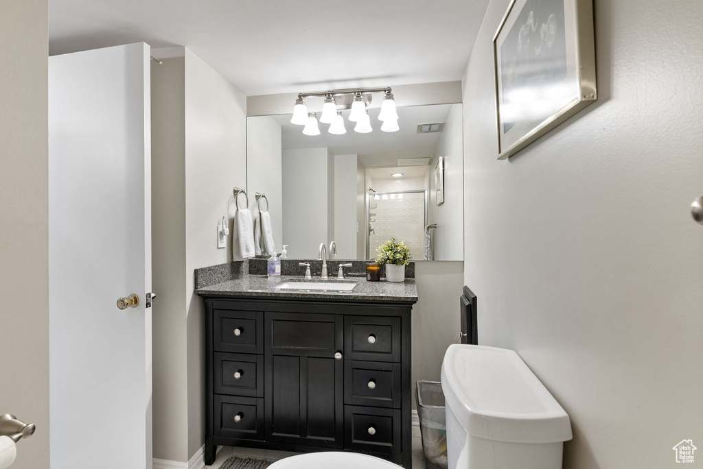 Full bathroom with vanity, toilet, and a shower