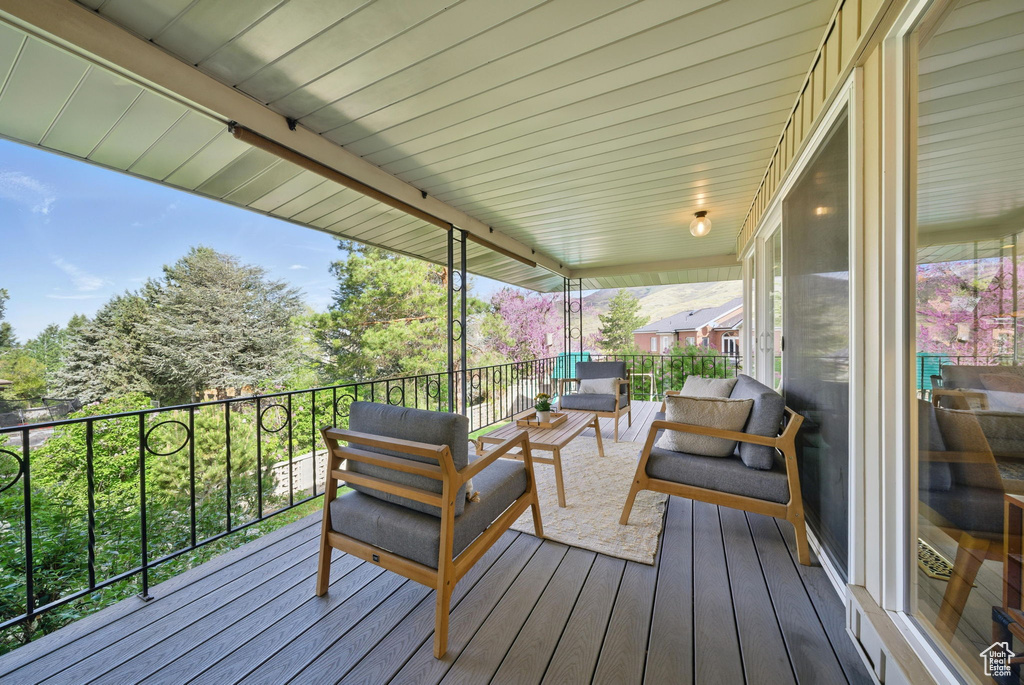 Wooden terrace featuring outdoor lounge area