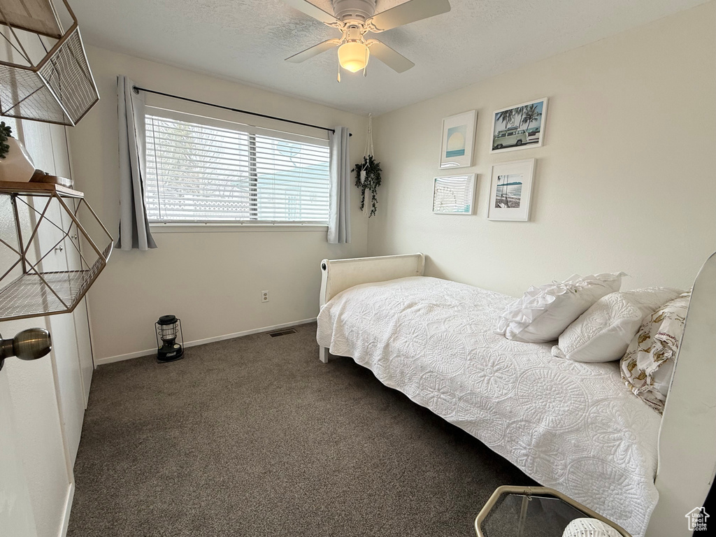 Bedroom with carpet floors, baseboards, ceiling fan, and visible vents
