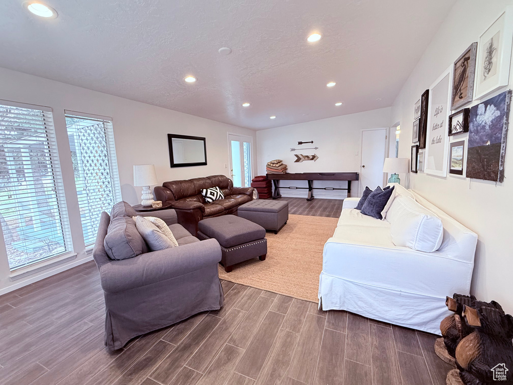Living room with plenty of natural light, recessed lighting, and wood finished floors