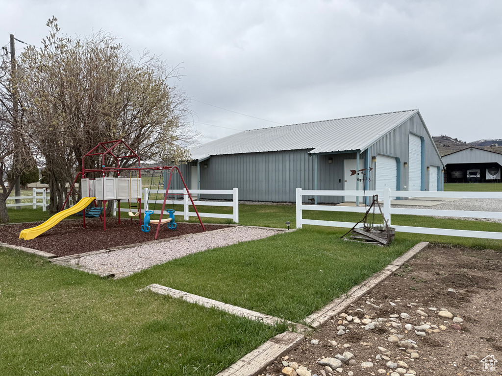 Communal playground featuring a lawn and fence