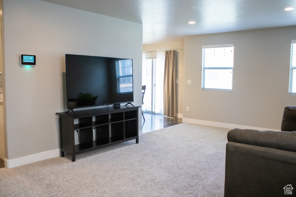 Carpeted living area featuring recessed lighting