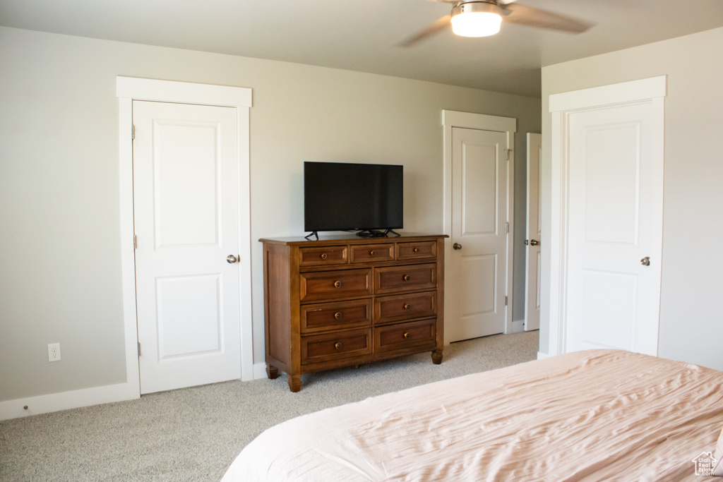 Bedroom featuring light colored carpet and a ceiling fan