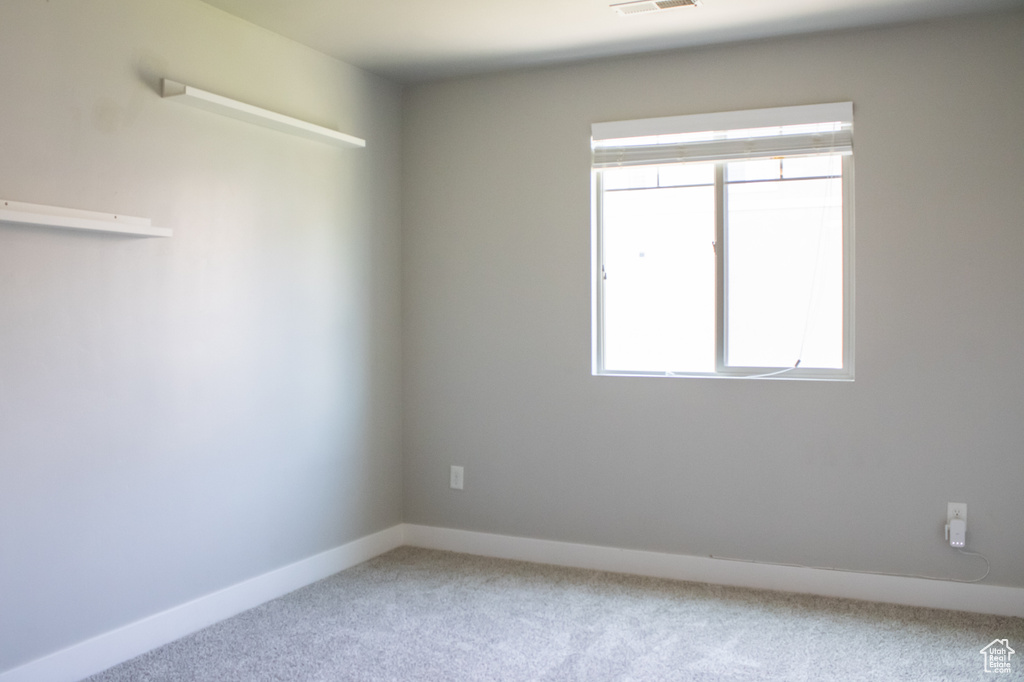 Carpeted empty room with healthy amount of natural light