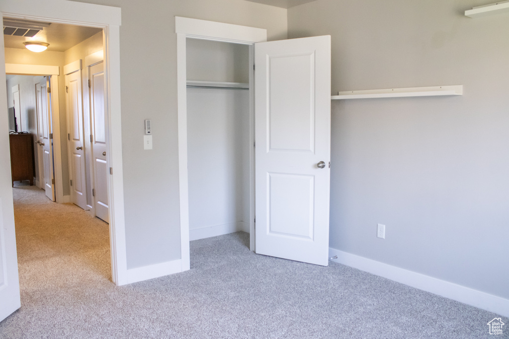 Unfurnished bedroom with carpet floors and a closet