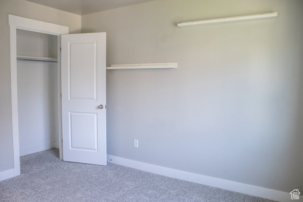 Unfurnished bedroom with carpet floors and a closet