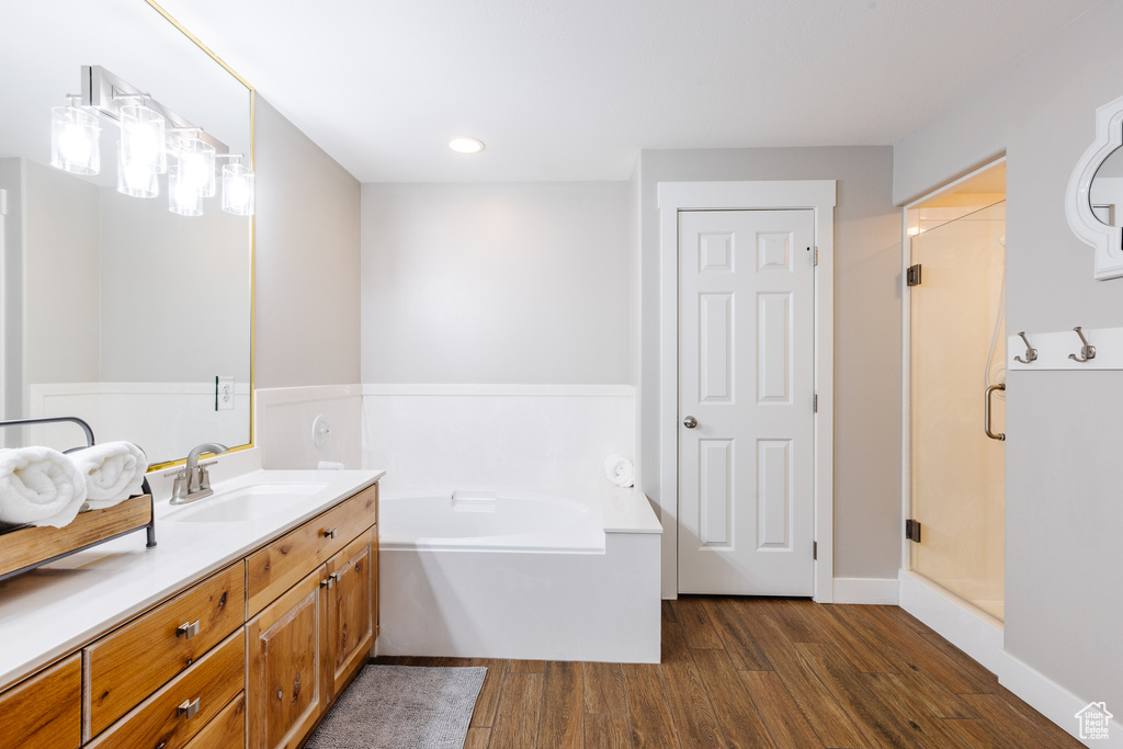 Bathroom featuring vanity, recessed lighting, a shower stall, wood finished floors, and a garden tub