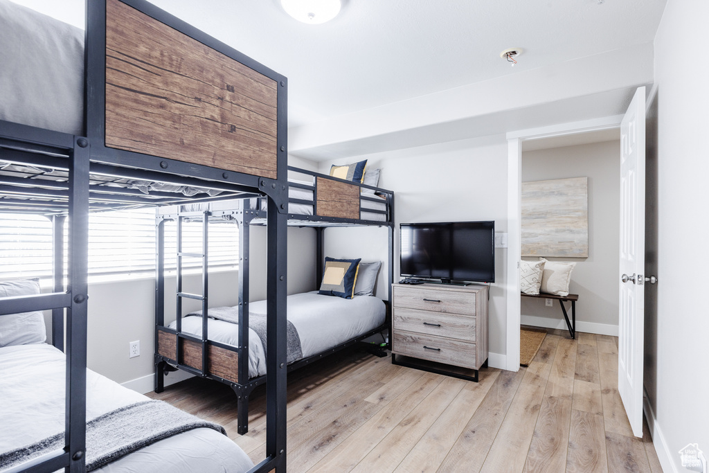 Bedroom with baseboards and light wood-type flooring