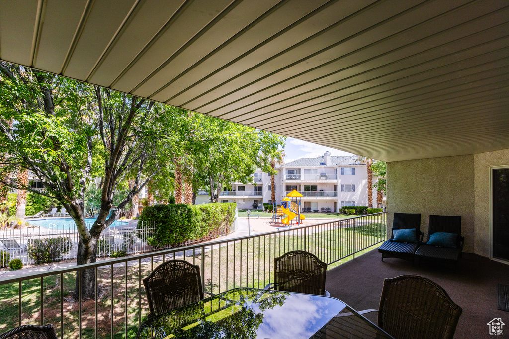 Balcony featuring outdoor dining area and a residential view
