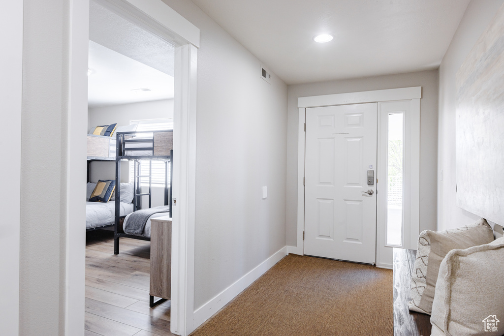 Entryway with baseboards, recessed lighting, and visible vents