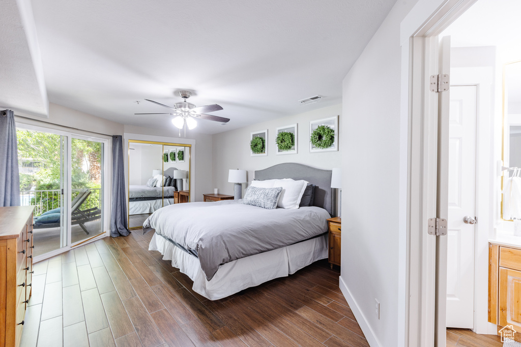 Bedroom featuring access to outside, a ceiling fan, wood finished floors, and visible vents