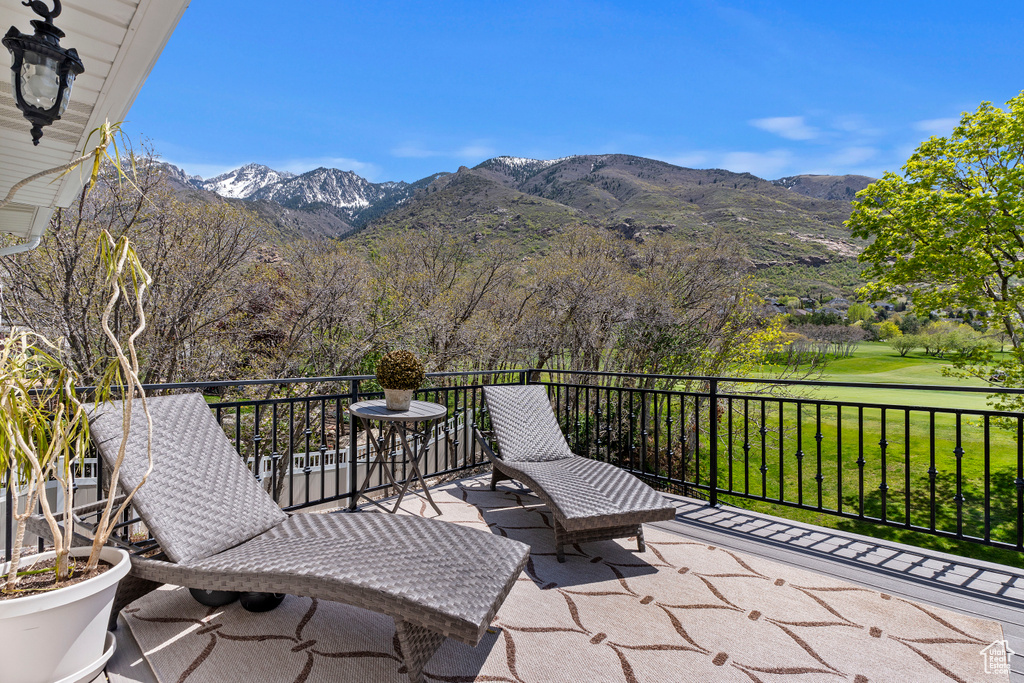View of patio featuring a mountain view and a balcony