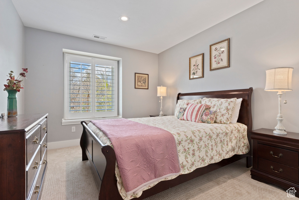 Bedroom featuring baseboards, visible vents, light carpet, and recessed lighting