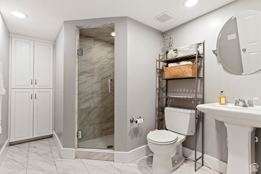 Full bathroom featuring recessed lighting, marble finish floor, a shower stall, and baseboards