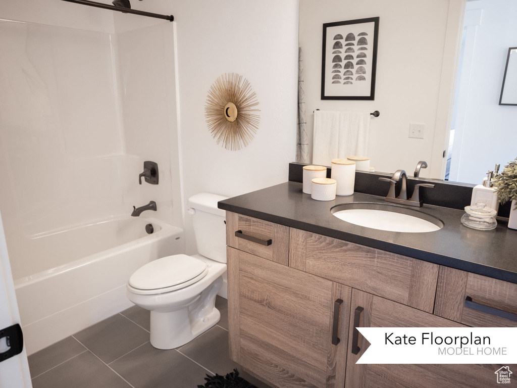 Full bathroom with vanity, tile patterned flooring, toilet, and  shower combination