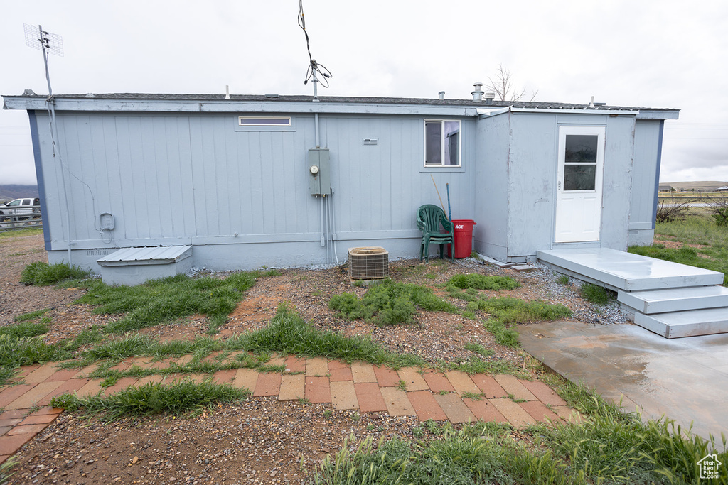 Back of house featuring central air condition unit