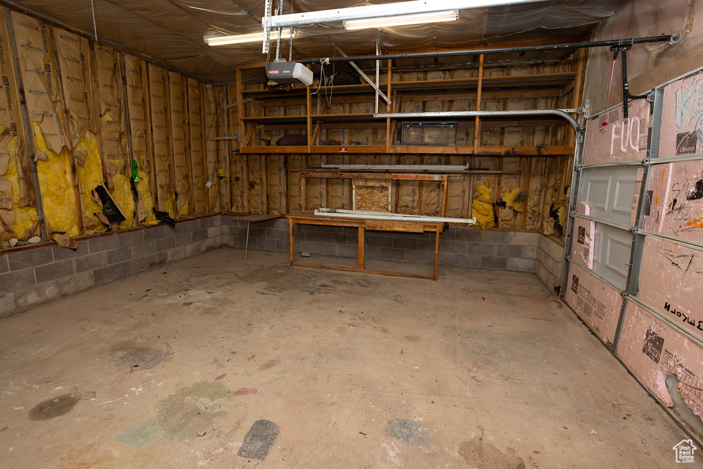 Basement featuring a garage and concrete block wall