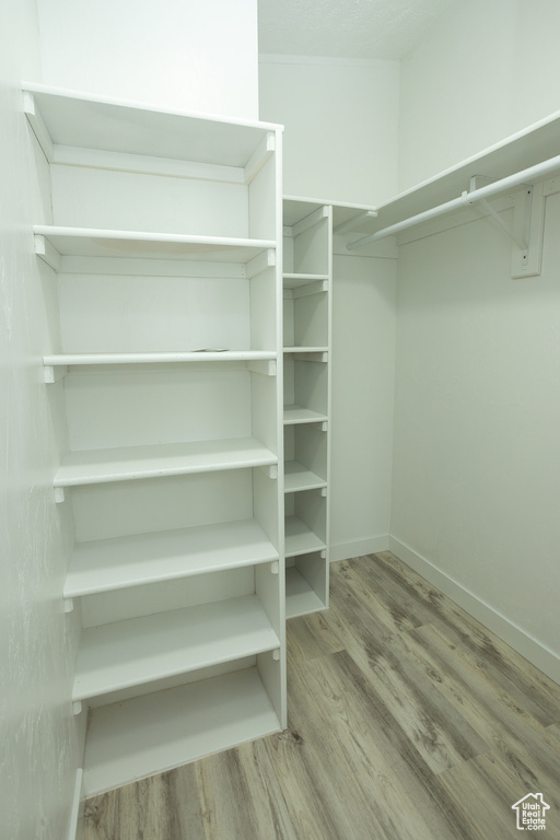 Spacious closet with wood finished floors