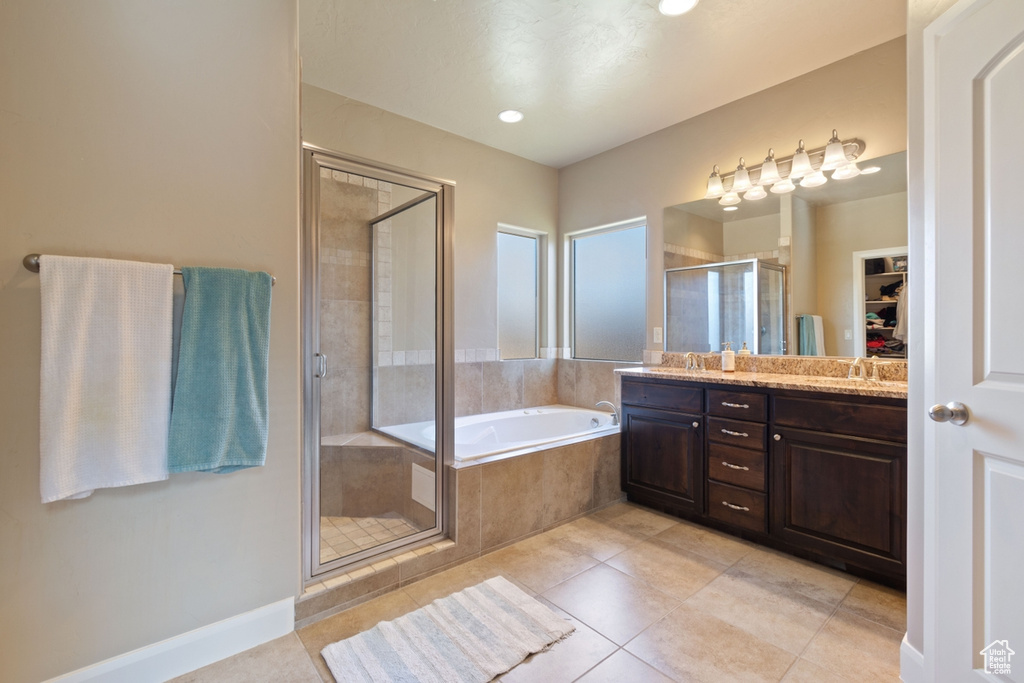 Bathroom featuring tile floors, vanity, and plus walk in shower
