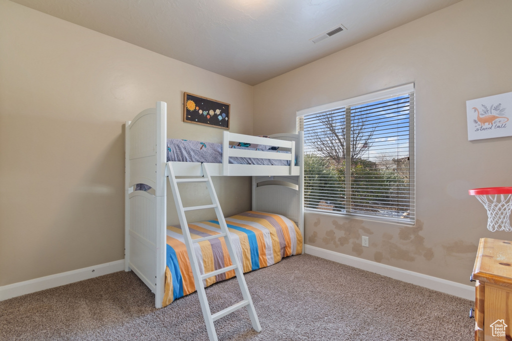 Bedroom with light colored carpet