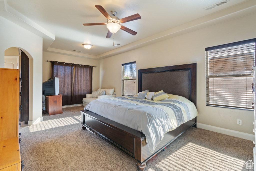 Carpeted bedroom featuring ceiling fan