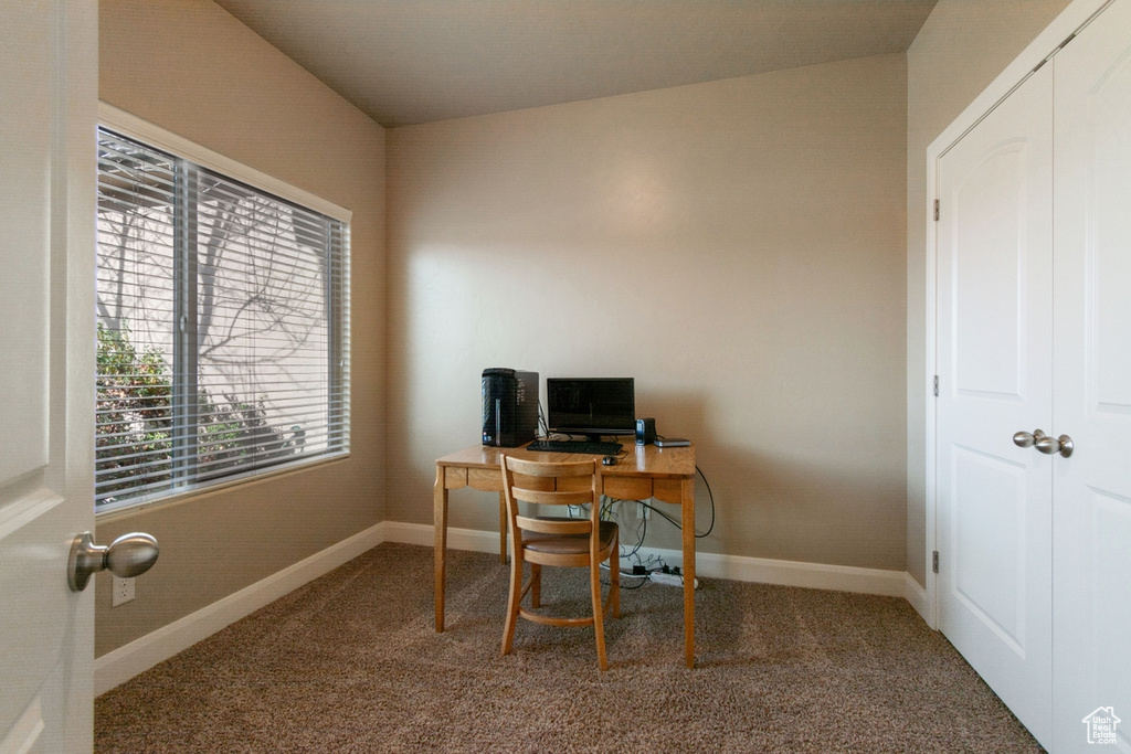 Office space featuring dark colored carpet