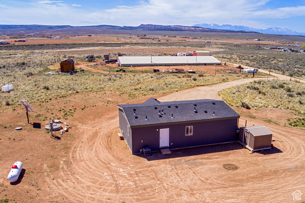 Aerial view featuring a mountain view, a rural view, and view of desert