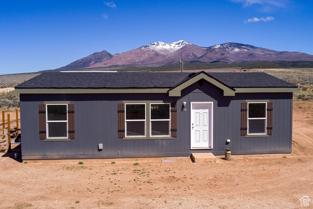 View of front facade featuring a shingled roof and a mountain view