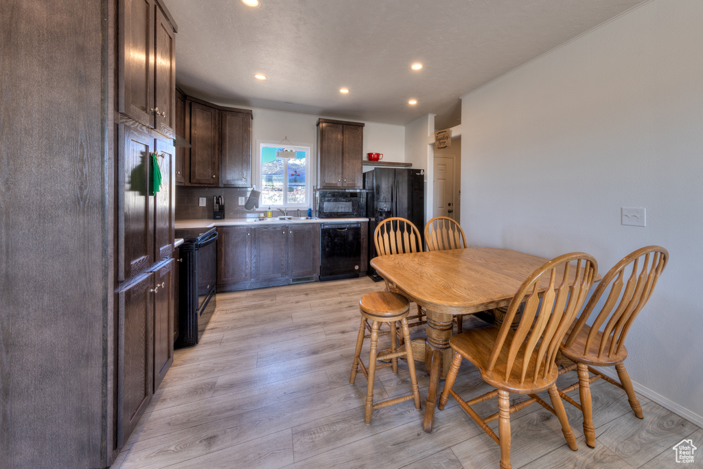 Dining room featuring recessed lighting, light wood finished floors, and baseboards