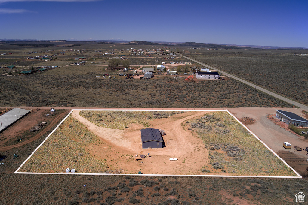 Birds eye view of property featuring a rural view and a desert view