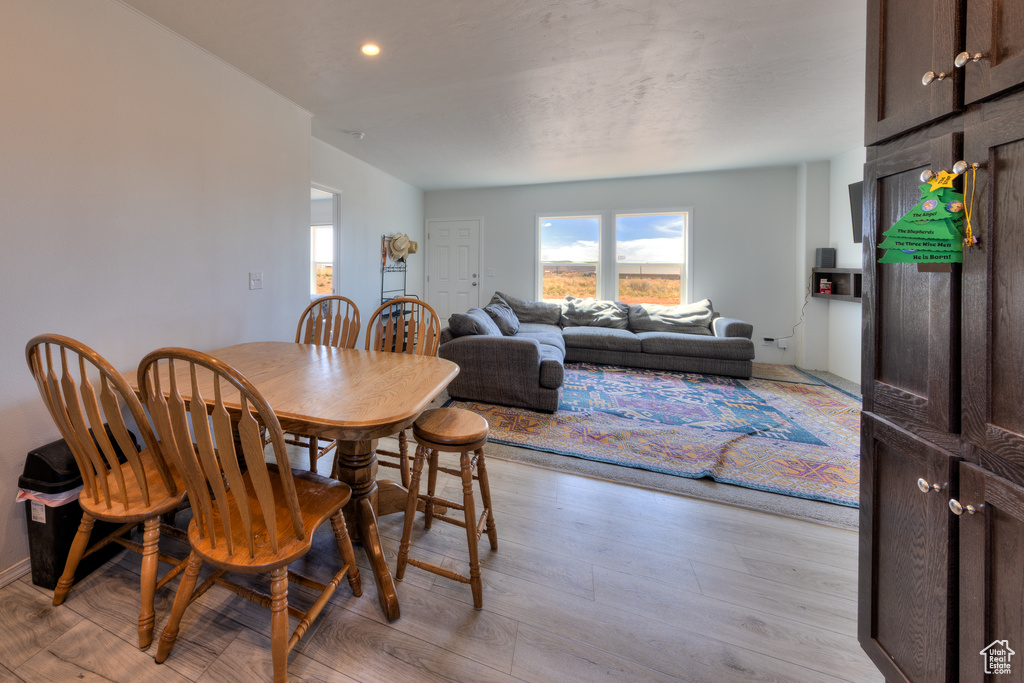 Dining room with recessed lighting, light wood-style flooring, and plenty of natural light