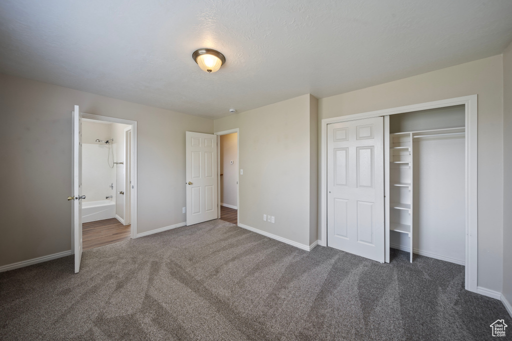 Unfurnished bedroom with carpet flooring, baseboards, and a closet