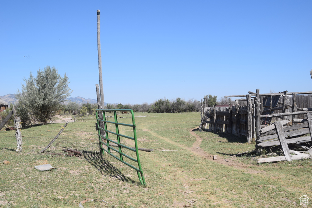 View of yard featuring a rural view and a mountain view