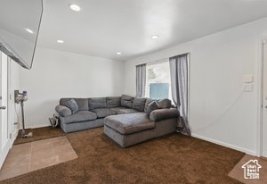 Carpeted living room with recessed lighting