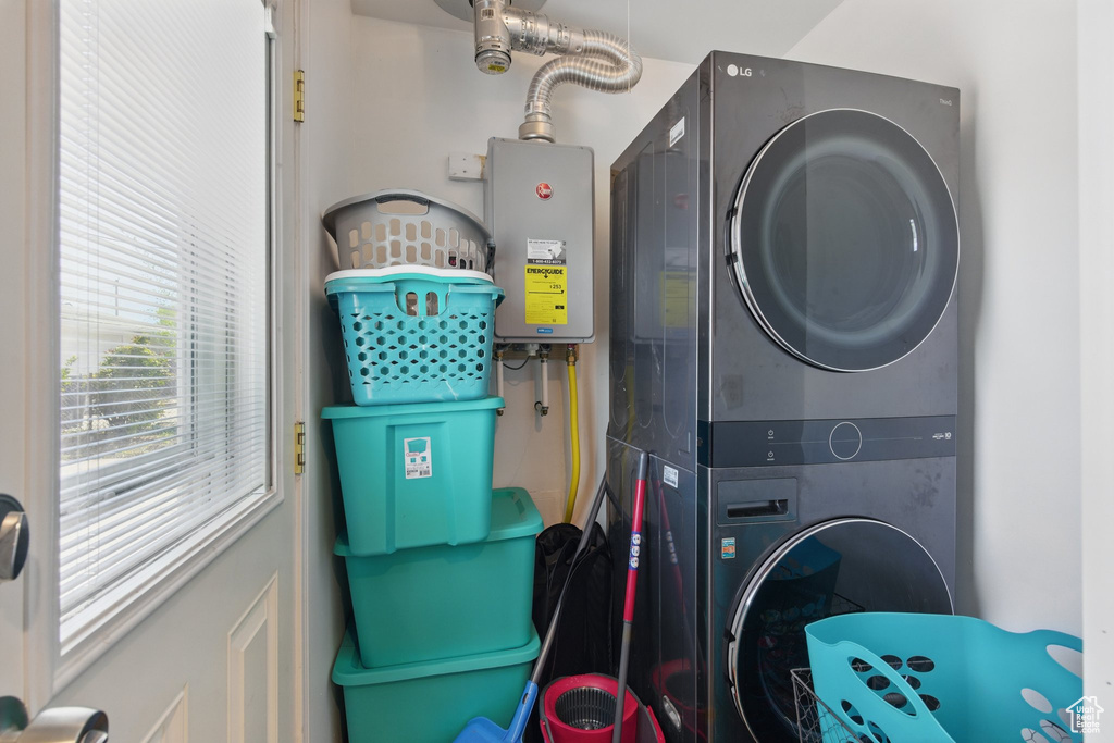 Laundry room featuring stacked washing maching and dryer and laundry area