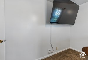 Detailed view of carpet flooring and baseboards