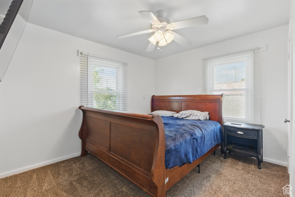 Bedroom featuring baseboards, ceiling fan, and carpet