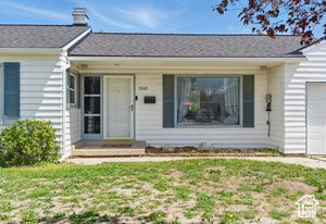 View of front facade featuring an attached garage and a porch