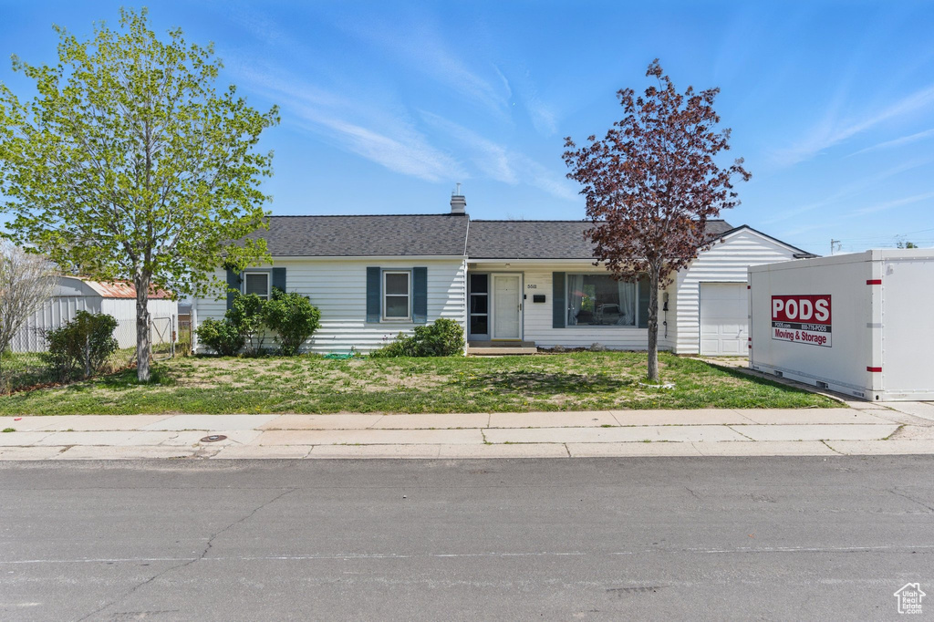 Single story home with a front lawn and an attached garage
