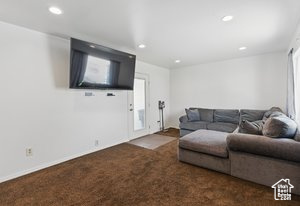 Living room with carpet flooring and recessed lighting