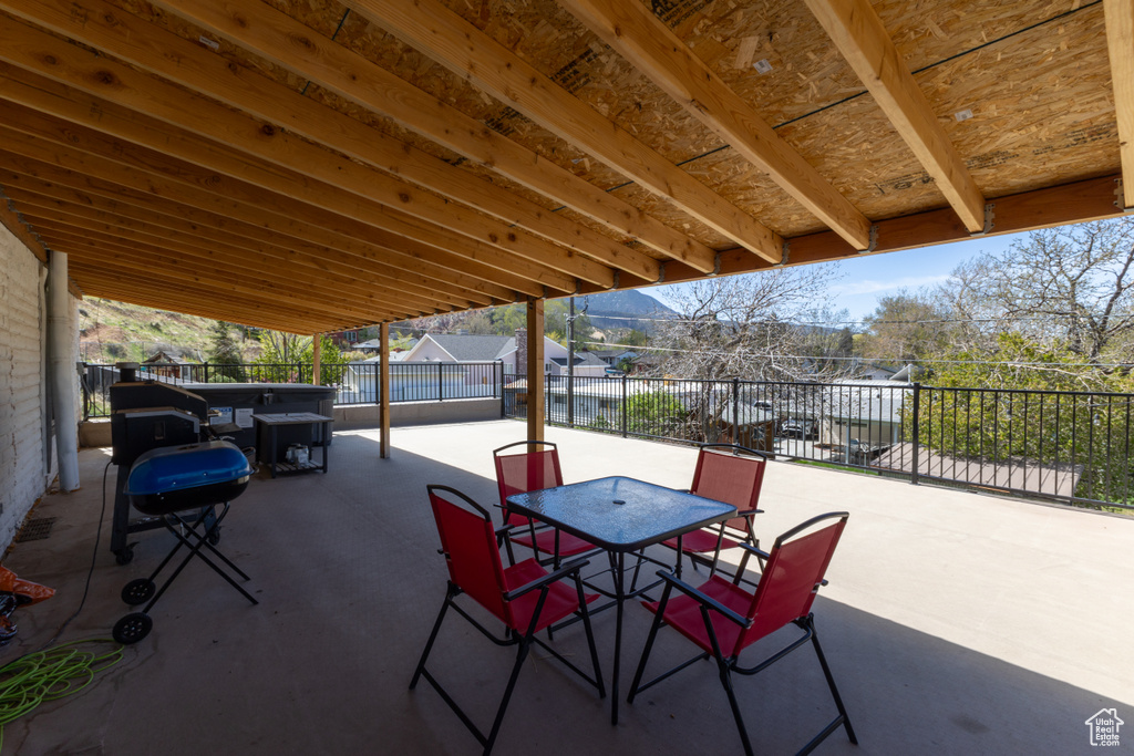 View of patio with a fenced backyard, grilling area, and outdoor dining space