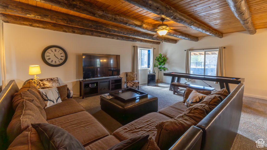 Living room with wooden ceiling, ceiling fan, beamed ceiling, and carpet flooring