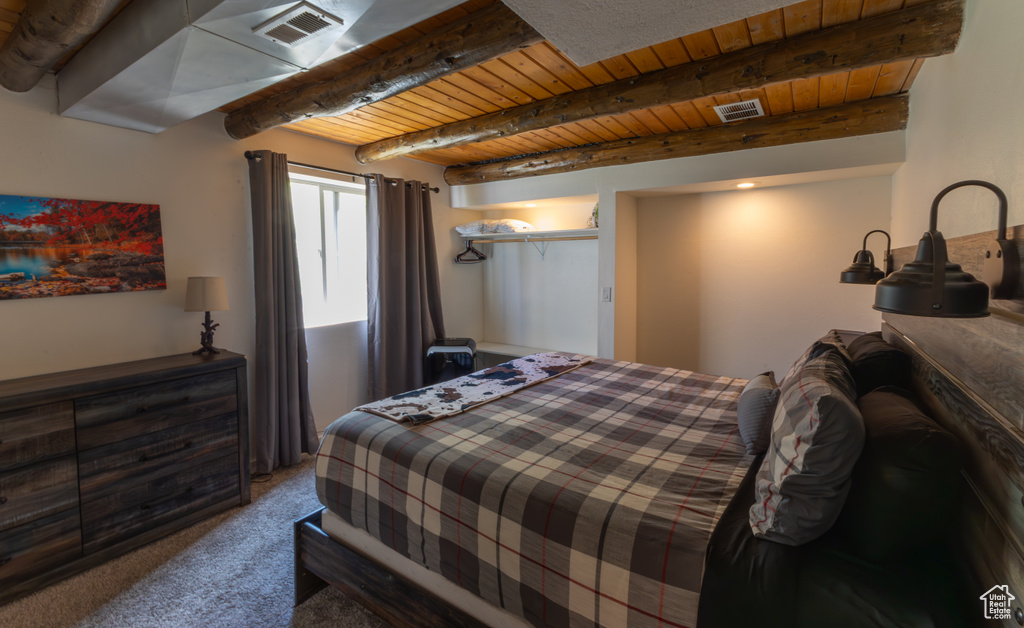 Bedroom featuring wood ceiling, carpet, beam ceiling, and visible vents