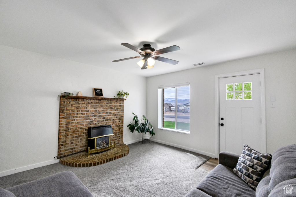 Living room with a ceiling fan, baseboards, and visible vents